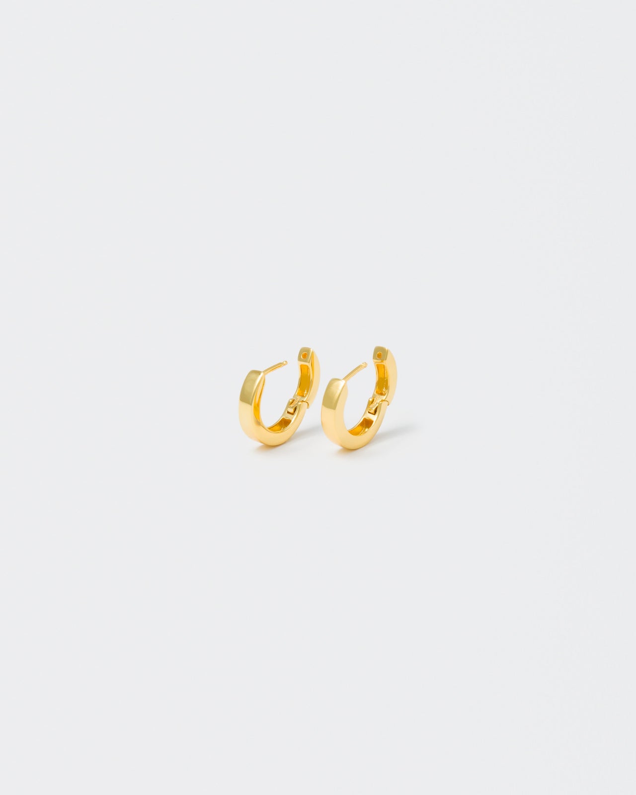 18k yellow gold coated hoop earrings with lasered logo and details on the inside